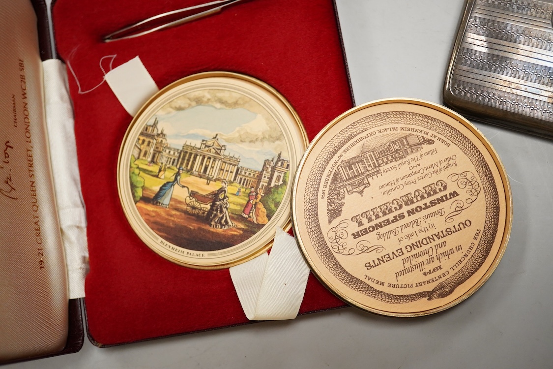 A cased engine turned sterling cigarette case, 11.4cm, a George V silver cigarette case and a cased commemorative limited edition silver gilt Churchill Centenary Picture Medal.